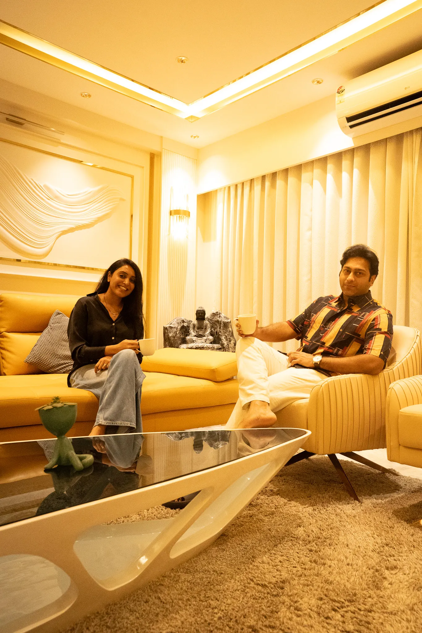 Homeowners relaxing in their new living room — Divyarjuna